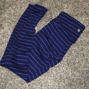 Athleta leggings with blue stripes.